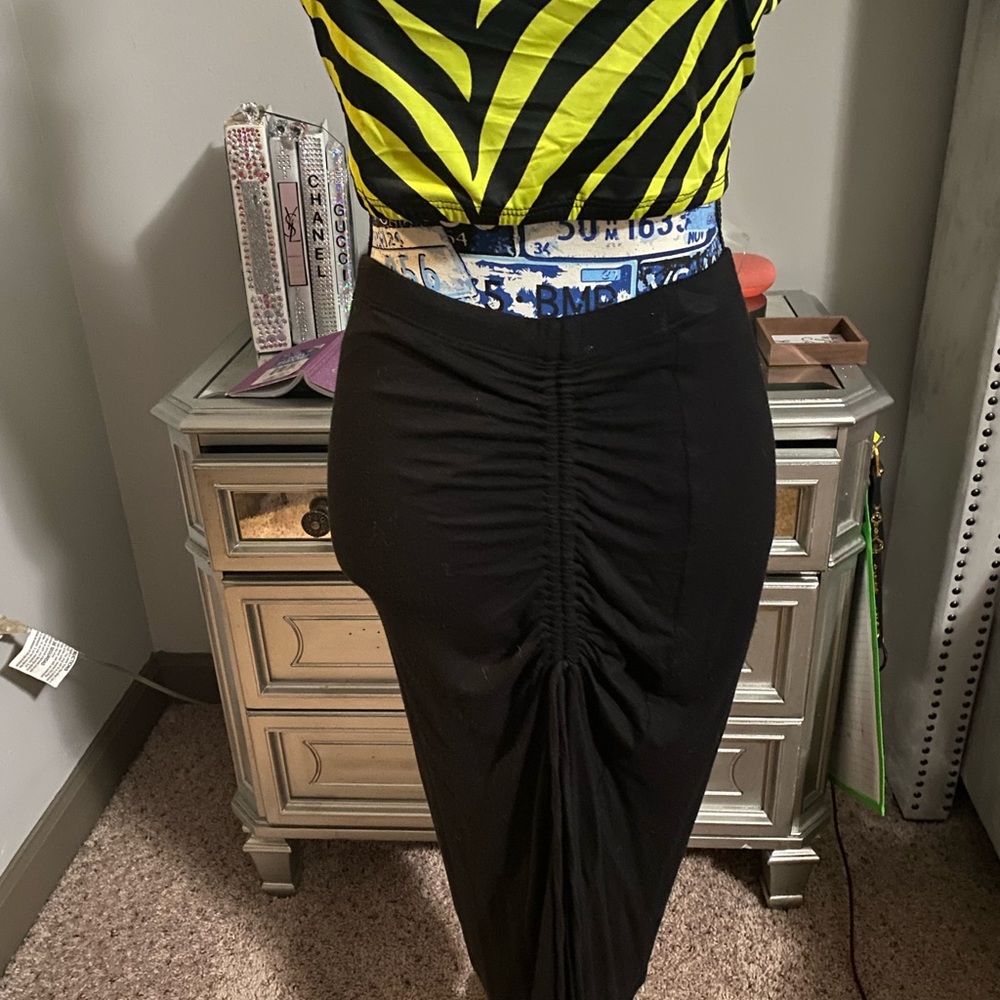 Calf length black skirt. Hugs curves